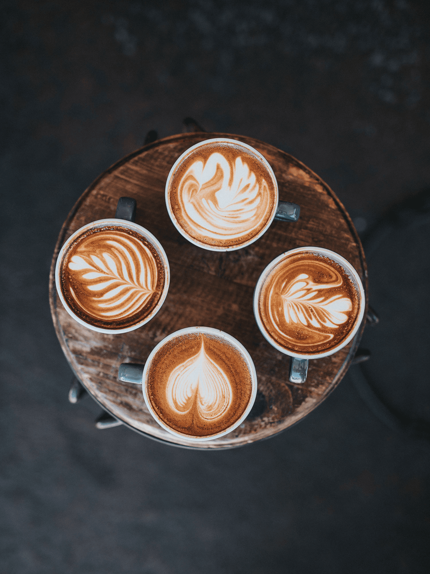 four coffees with latte art